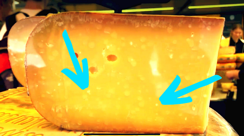 A visual representation of cheese with crystals