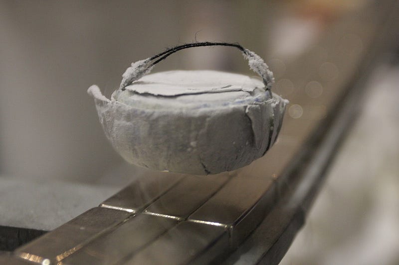 Superconductor levitating over a magnetic railway — WikiCC