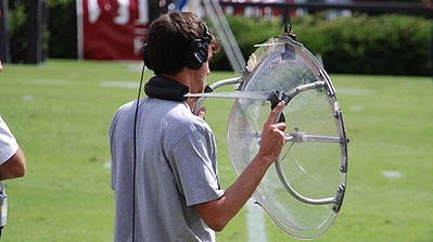 Parabolic microphone in use at a football game