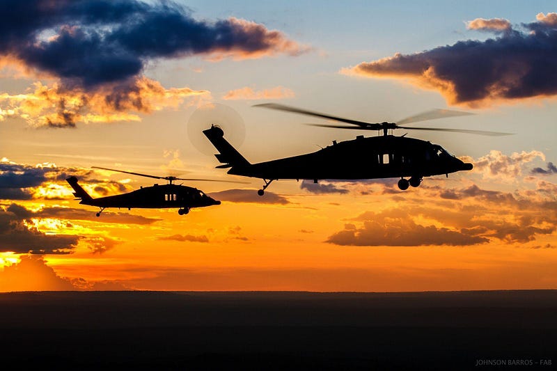 Unmarked black helicopter in flight