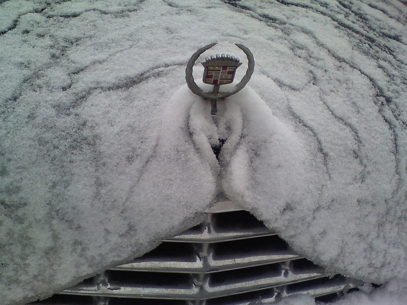 Snow covering a car, showcasing winter photography